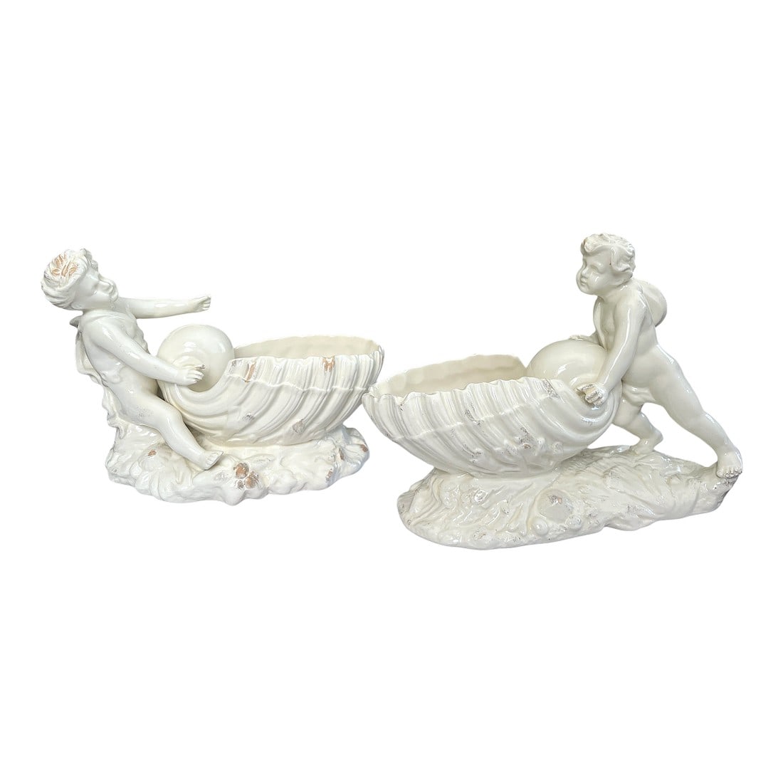 Large Vintage Signed Staffordshire Style Cherubs and Shell Bowls Cache Pot Vases After Minton Royal: Charming and romantic pair of vintage ceramic centerpieces features classical cherubs perched against giant shell bowls, rendered in a glossy cream salt glaze, signed In the style of 19th-century