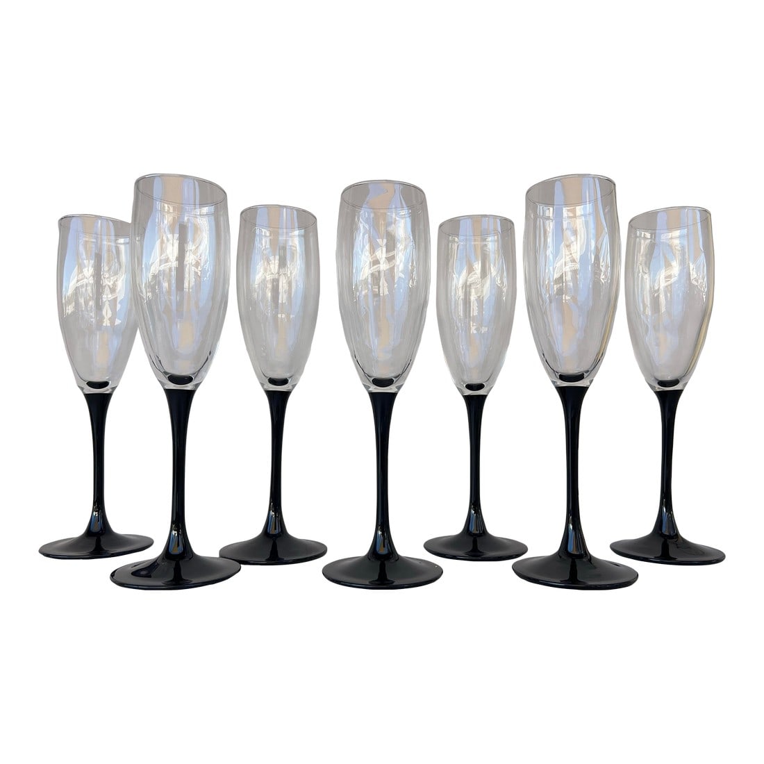 Vintage Black Stem Champagne Flute Glasses Styles After Cristal d'Arques- Durand Set of 7: Long stem Flute Champagne Glasses. The bowl is clear glass and the stem/ base is black. The base is 2.75" .The rim is 2" the height is about 8.5". Unmarked by Cristal D'Arques- Durand Condition: