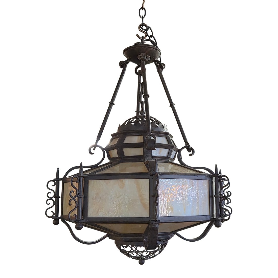 Marakesh 4 Light Iron Pendant Chandelier: This very large and very heavy solid iron chandelier appears to be from designer Steven Handalman studios in Santa Barbara California. It features stunning iron design work and colored stained glass