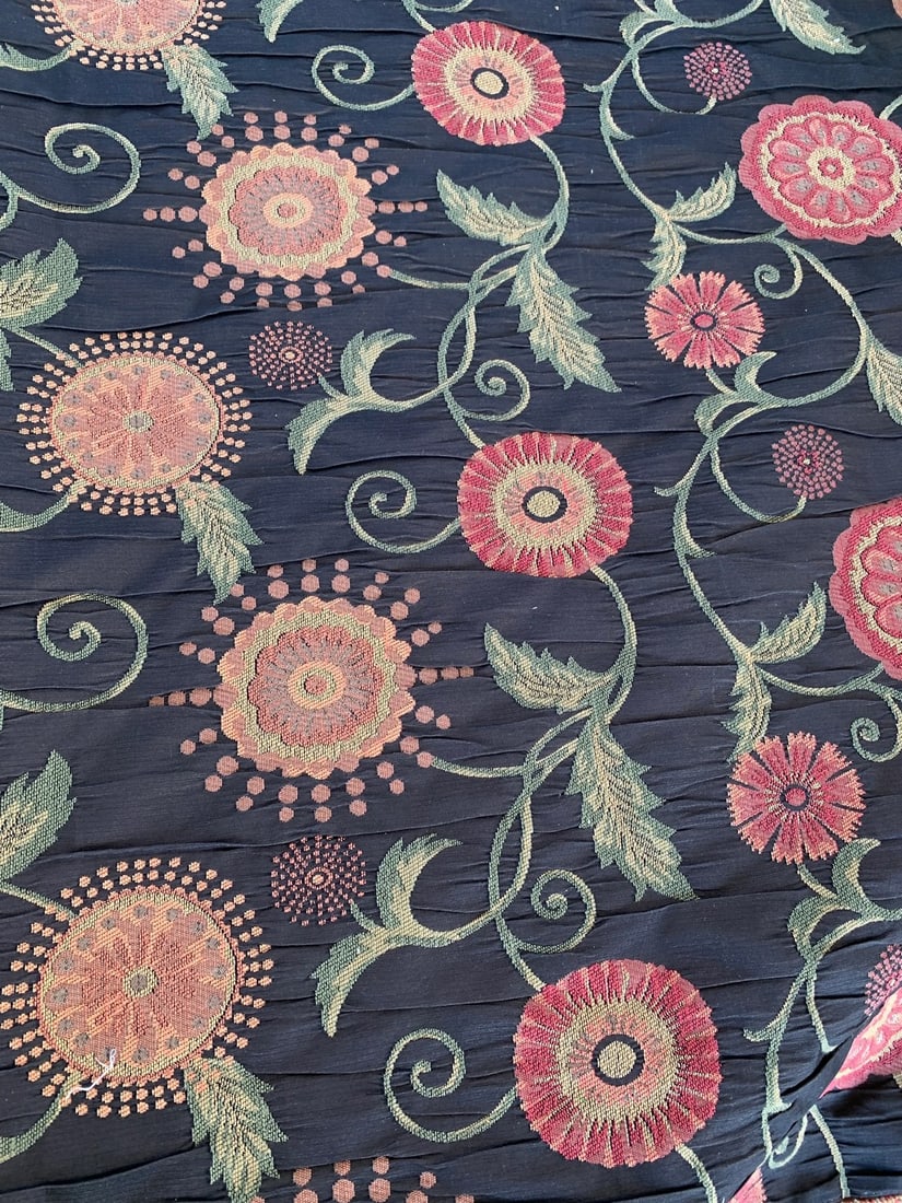 Vintage Black Floral Jaquard Upholstery Fabric- 11 yards: 11 yards of this Beautiful fabric on the roll. The black fabric on top is creased with what appears to be colorful embroidered flowers. The flowers have shades of orange ( rust, peach, Red,