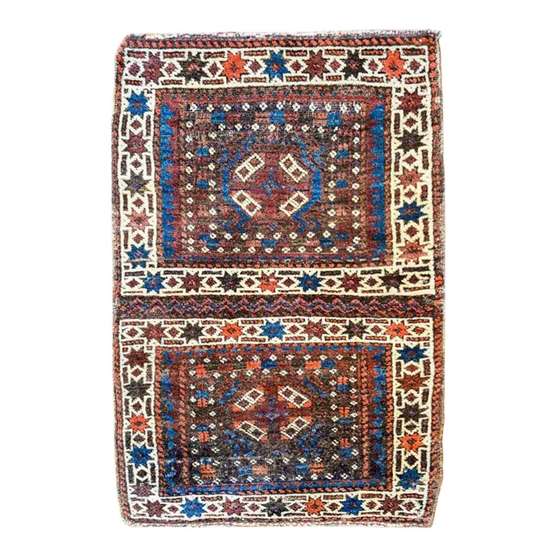Early 20th Century Turkman Rug: A beautiful early 20th century Persian Turkmen rug composed with two squares each with its own medallion amidst fields of stylized flowers, surrounded by matching stylized flower borders, all woven