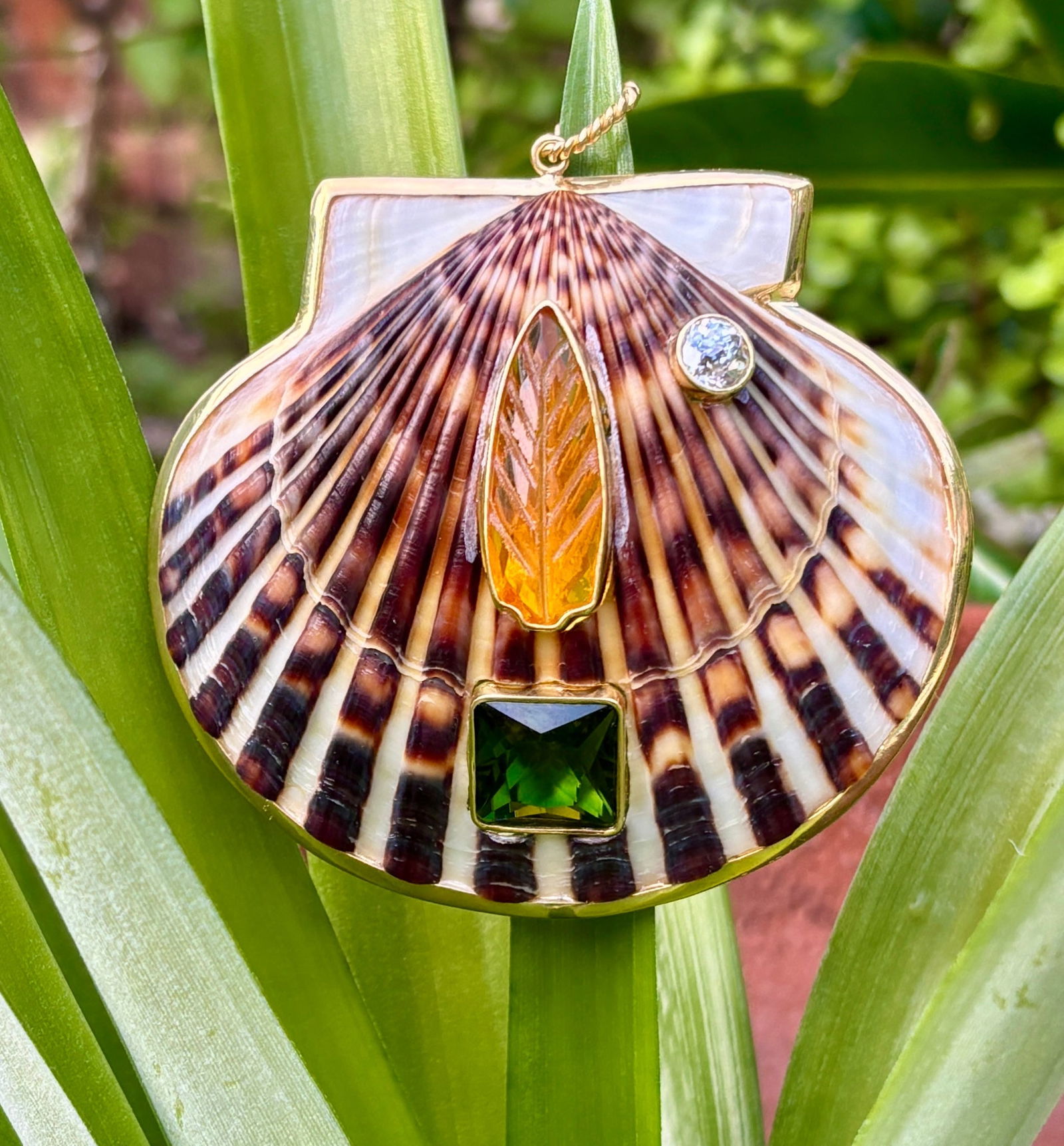 St. James Topiary and Moon Pendant: Title:St. James Topiary and Moon PendantDescription:Whimsical and very elegant, this common, brown Chatham Scallop is organically beautiful in its own right, but it sure is kicked up a notch with the