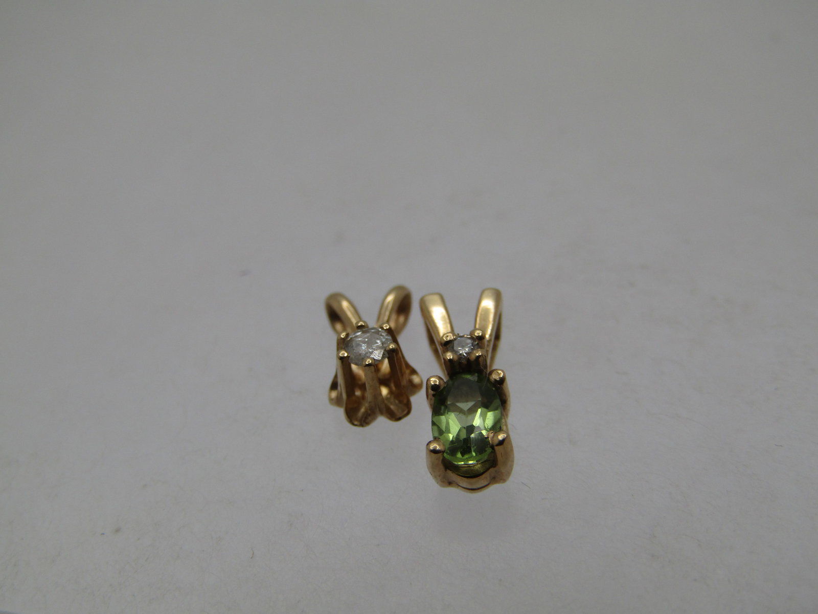 Vintage 14kt Peridot Diamond Pendant and 14kt Diamond Pendant, 1970's-1980's: Title:Vintage 14kt Peridot Diamond Pendant and 14kt Diamond Pendant, 1970's-1980'sDescription:Vintage 14kt Peridot Diamond Pendant and 14kt Diamond Pendant, 1970's-1980's. The diamond has a v-shaped