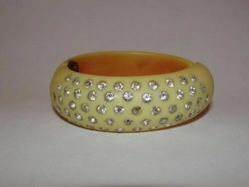Butterscotch Bakelite Rhinestone Clamper Bracelet: Title:Butterscotch Bakelite Rhinestone Clamper BraceletDescription:Gorgeous and very collectible. Circa 1940's. Butterscotch bakelite bracelet. Bracelet measures just over 3/4" wide. Internally