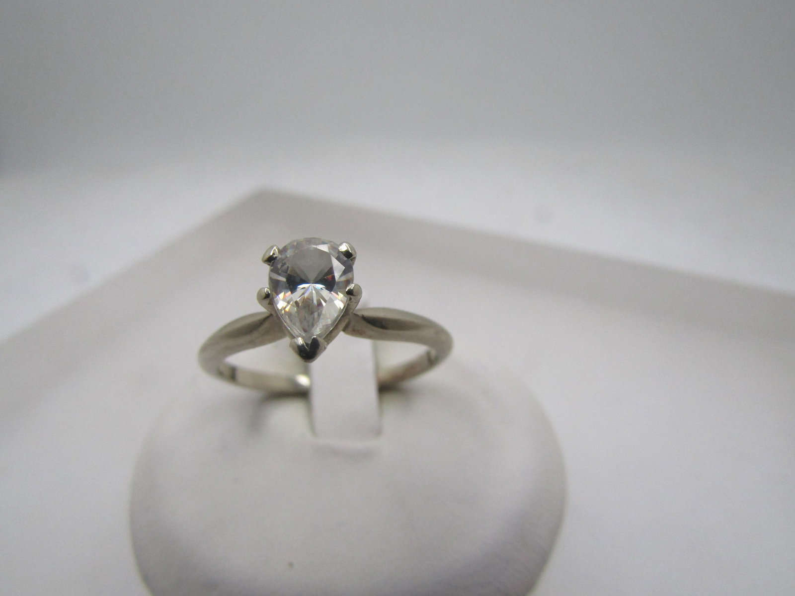 Vintage 14kt Pear-Shaped CZ Engagement Ring, 1 CTW, Sz. 8. 1970's-1980's: Title:Vintage 14kt Pear-Shaped CZ Engagement Ring, 1 CTW, Sz. 8. 1970's-1980's Description:Vintage 14kt Pear-Shaped CZ Engagement Ring, 1 CTW, Sz. 8. 1970's-1980's. It is white gold, marked 14kt and t