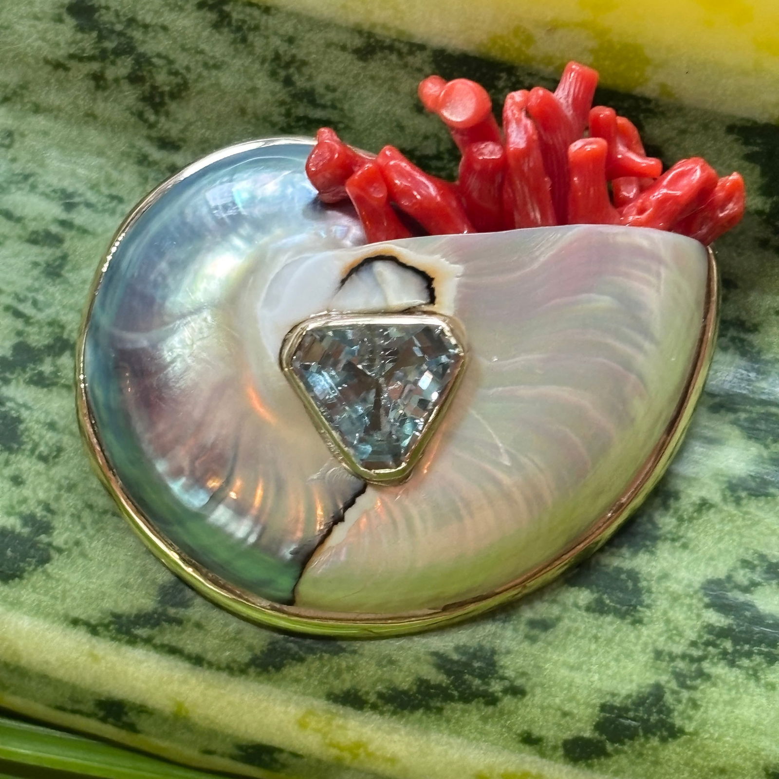 Nautilus Brooch with Aquamarine & Red Coral: Title:Nautilus Brooch with Aquamarine & Red Coral Description:Swanky Nautilus Brooch sporting a Trillon-cut Aquamarine and Italian Coral spilling out the top - signed CSS - Vermeil - 2"w. Reserve: $1,
