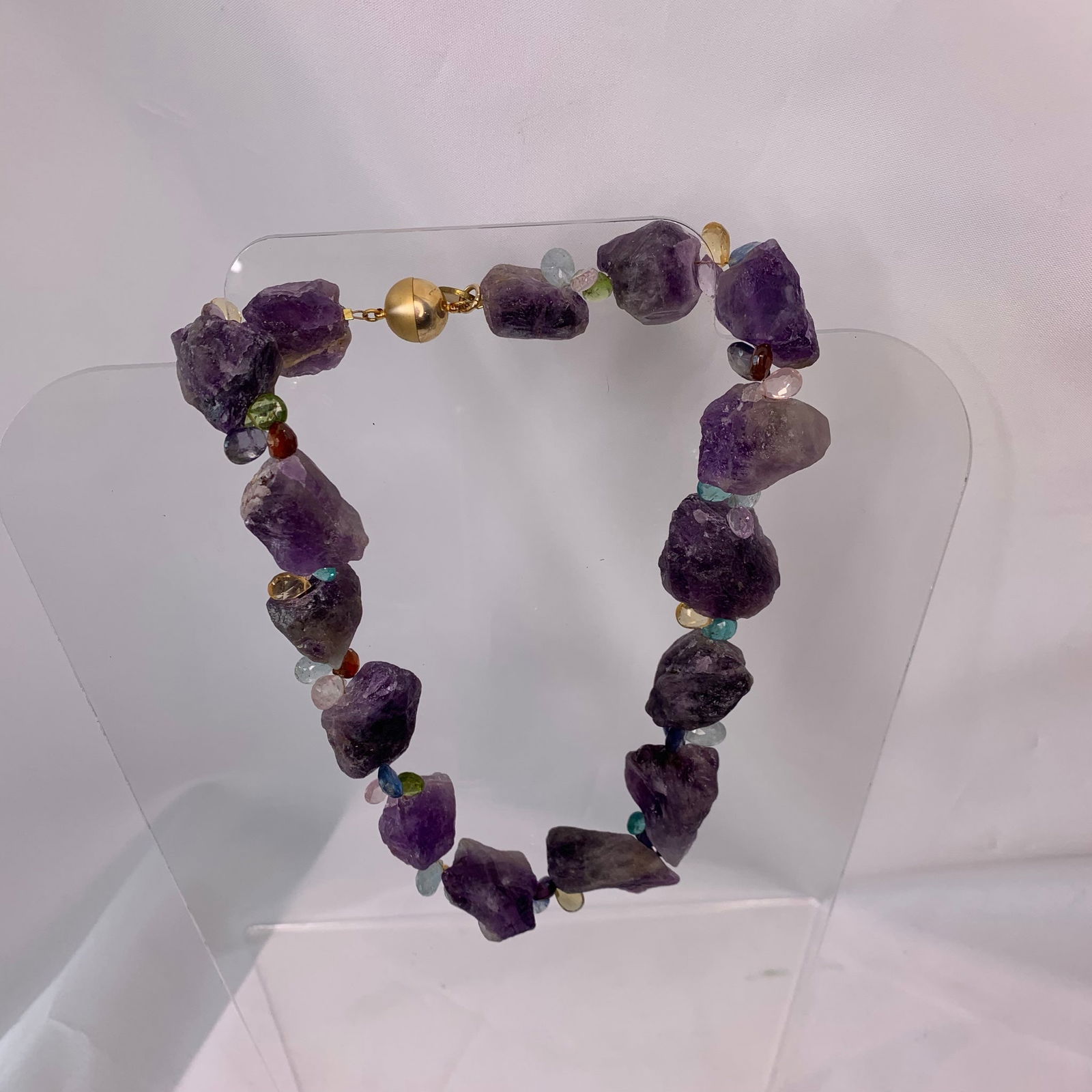 Raw Amethyst Necklace: Title:Raw Amethyst NecklaceDescription:Rough, raw Amethyst chunks mixed with fine, faceted Citrine briolettes, this cheerful necklace offers the juxtaposition of rowdy and refined, depending with