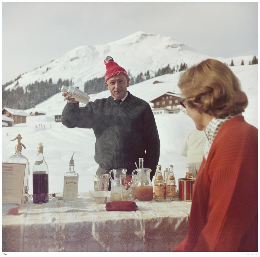 Lech Ice Bar 1960 - Slim Aarons Estate Stamped: 1960 (printed later): Title: Lech Ice Bar 1960 - Slim Aarons Estate Stamped: 1960 (printed later) Description: Lech Ice Bar 1960 - Slim Aarons Estate Stamped A bartender mixes a drink for a customer at the Ice Bar at the H