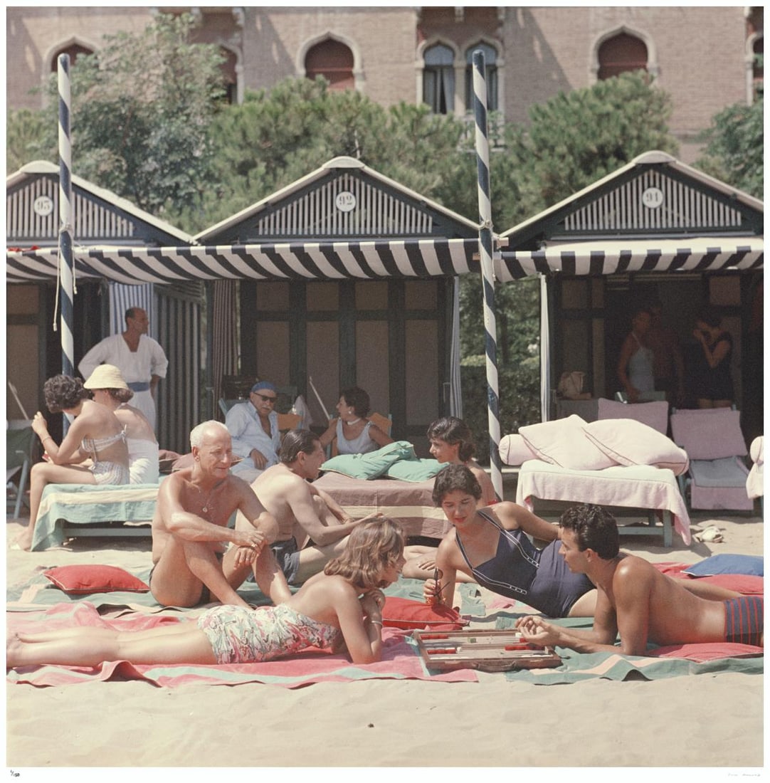 Beach Backgammon 1957 - Slim Aarons Estate Stamped: 1957 (printed later): Title: Beach Backgammon 1957 - Slim Aarons Estate Stamped: 1957 (printed later) Description: Beach Backgammon 1957 - Slim Aarons Estate Stamped Backgammon on the beach at the Hotel Excelsior on the Ve
