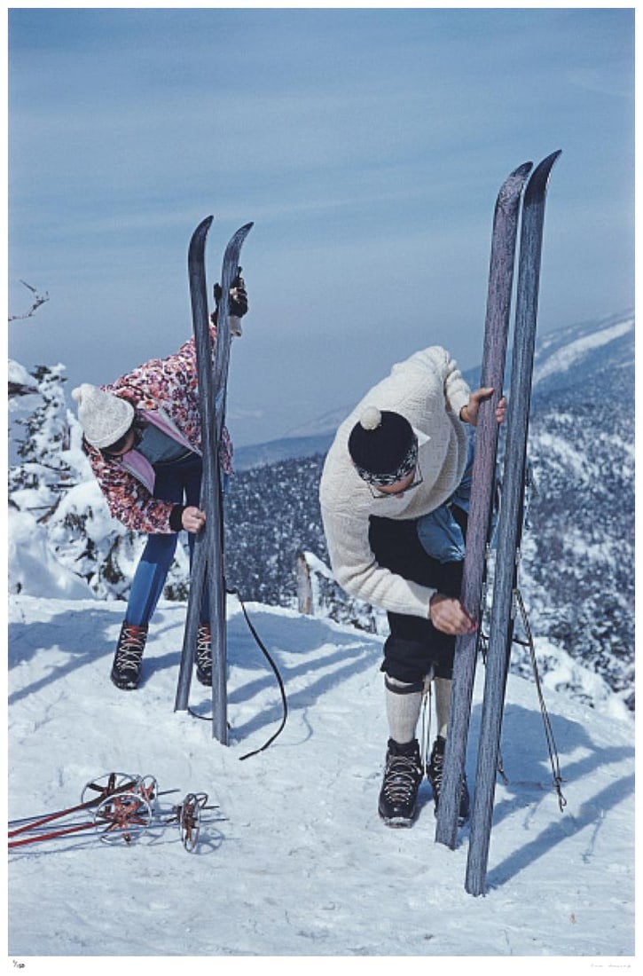 On The Slopes Of Sugarbush 1960 - Slim Aarons Estate Stamped: 1960 (printed later): Title: On The Slopes Of Sugarbush 1960 - Slim Aarons Estate Stamped: 1960 (printed later) Description: On The Slopes Of Sugarbush 1960 - Slim Aarons Estate Stamped Two skiers inspecting their skis on