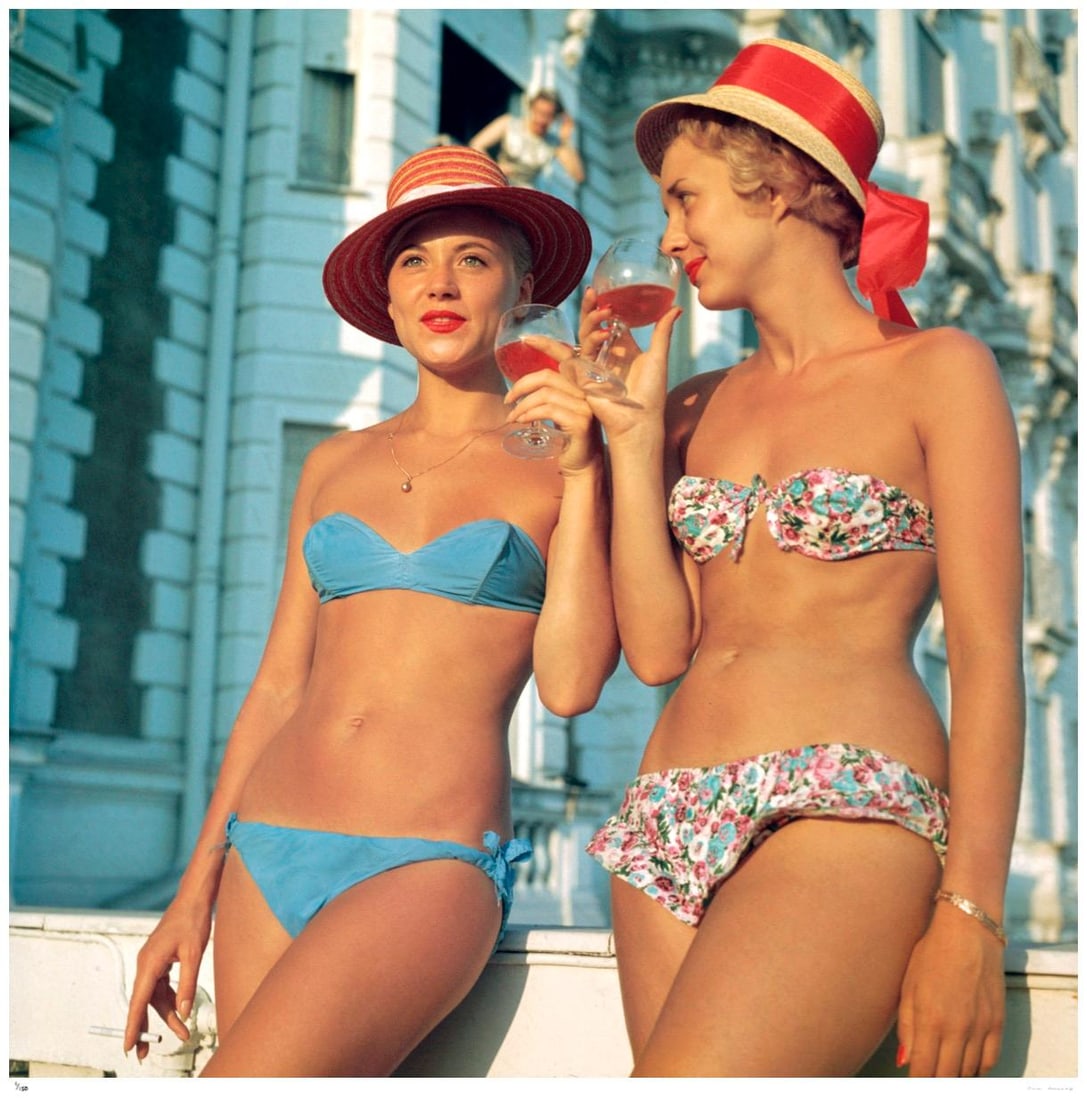 Sundowners 1960 - Slim Aarons Estate Stamped: 1960 (printed later): Title: Sundowners 1960 - Slim Aarons Estate Stamped: 1960 (printed later) Description: Sundowners 1960 - Slim Aarons Estate Stamped Two bikini-clad holidaymakers enjoy a glass of wine outside the