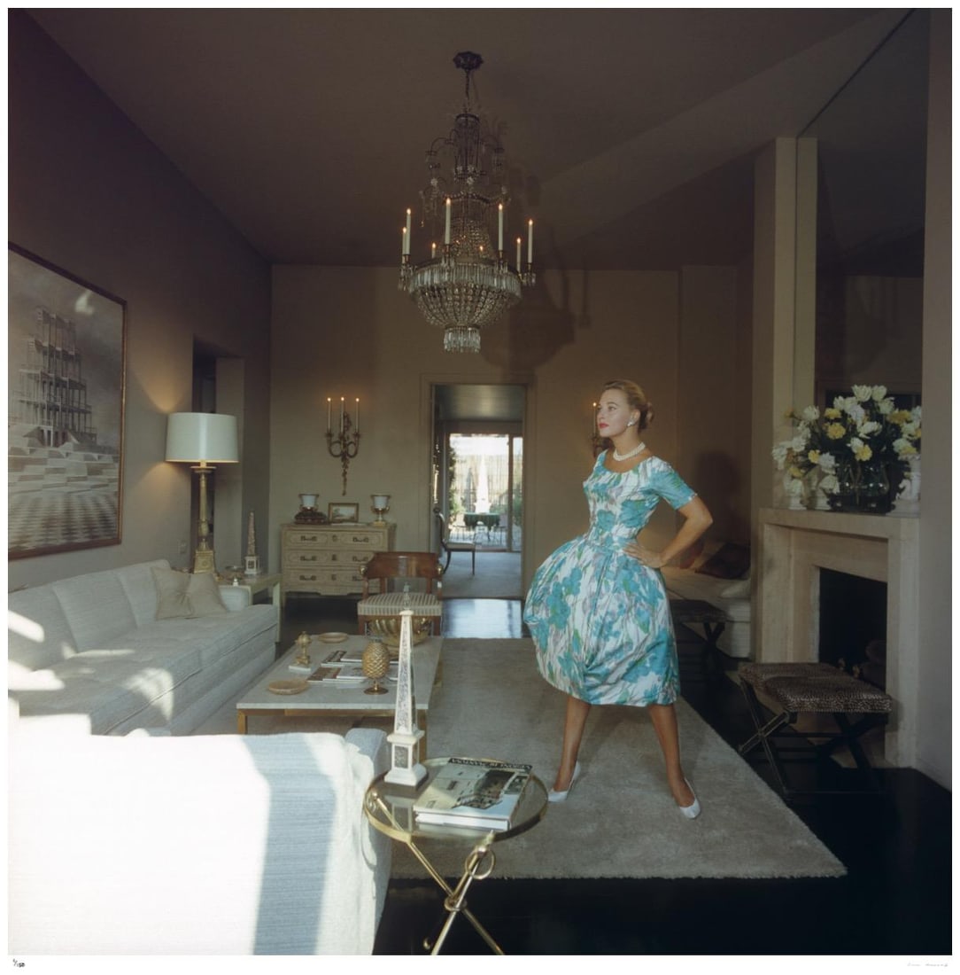 San Diego Home 1956 - Slim Aarons Estate Stamped: 1956 (printed later): Title: San Diego Home 1956 - Slim Aarons Estate Stamped: 1956 (printed later) Description: San Diego Home 1956 - Slim Aarons Estate Stamped A woman in a day dress in the sitting room of a house in
