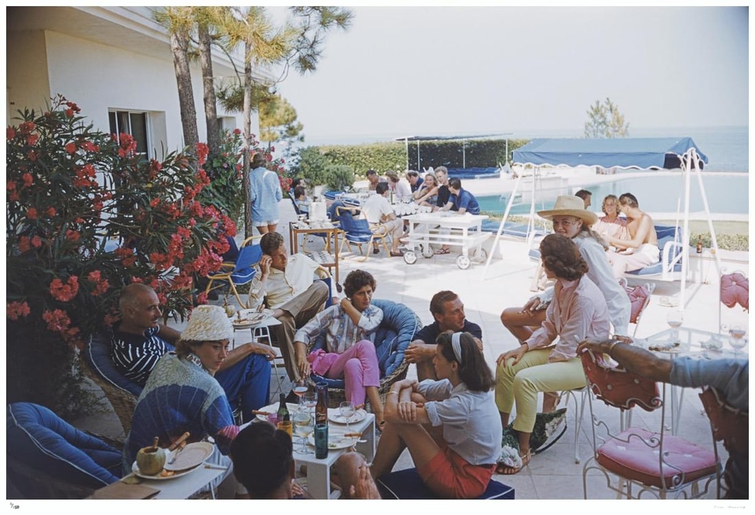 Riviera Crowd 1957 - Slim Aarons Estate Stamped: 1957 (printed later): Title: Riviera Crowd 1957 - Slim Aarons Estate Stamped: 1957 (printed later) Description: Riviera Crowd 1957 - Slim Aarons Estate Stamped Holidaymakers enjoying lunch by a pool on the French Riviera,
