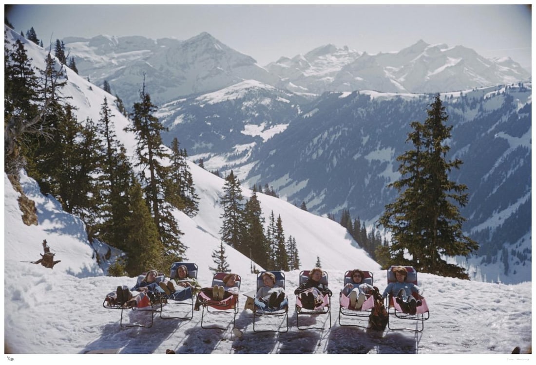 Lounging in Gstaad 1961 - Slim Aarons Estate Stamped: 1961 (printed later): Title: Lounging in Gstaad 1961 - Slim Aarons Estate Stamped: 1961 (printed later) Description: Lounging in Gstaad 1961 - Slim Aarons Estate Stamped Holidaymakers in sun loungers on the slopes at at Gs