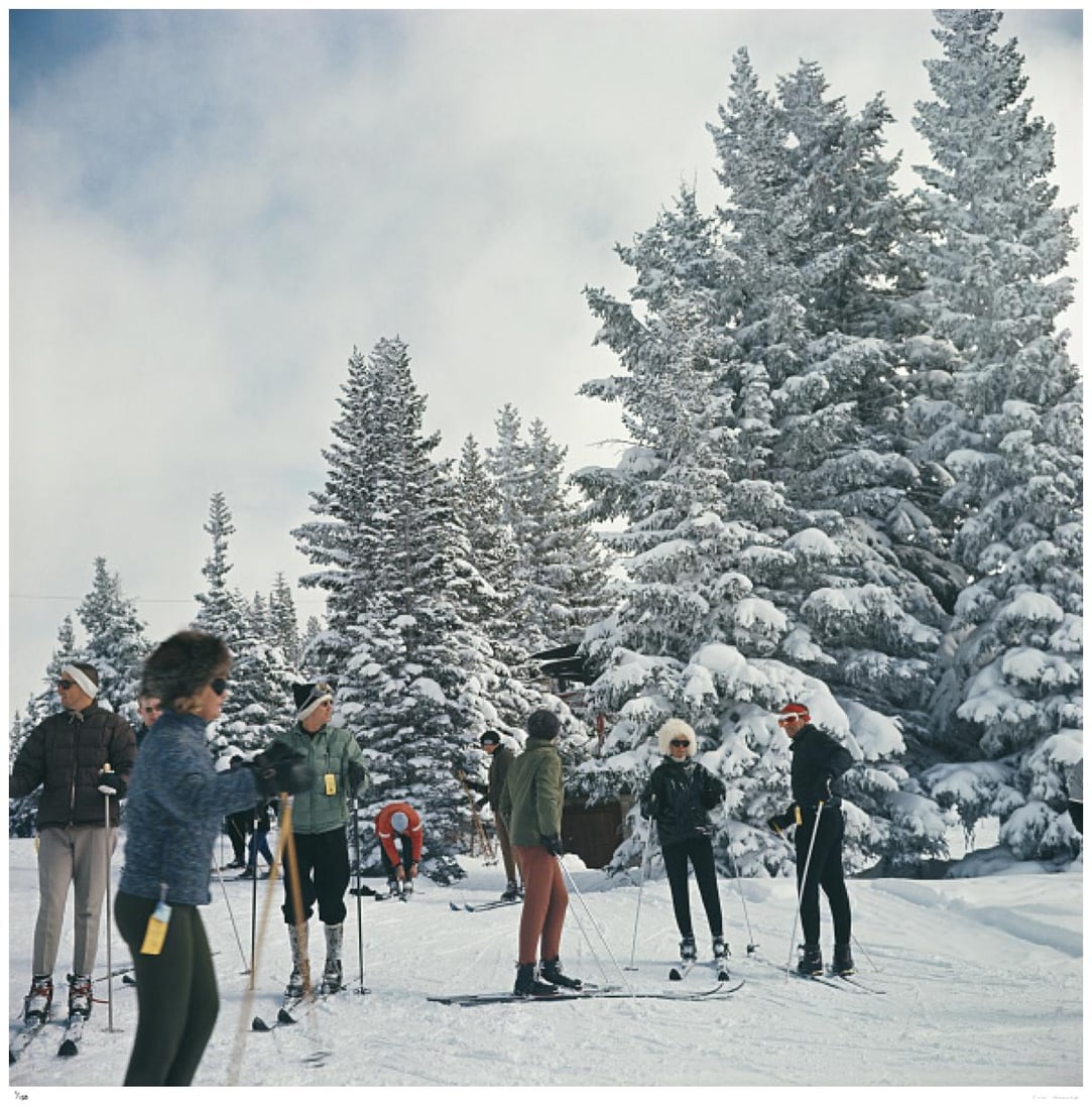 Skiing in Vail 1964 - Slim Aarons Estate Stamped: 1964 (printed later): Title: Skiing in Vail 1964 - Slim Aarons Estate Stamped: 1964 (printed later) Description: Skiing in Vail 1964 - Slim Aarons Estate Stamped A group of skiers standing next to snow covered trees in Vai