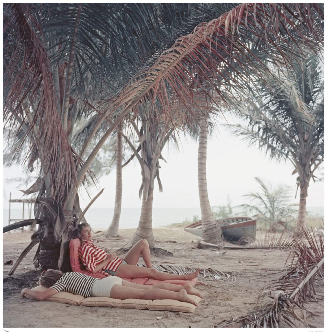 Marsha Gayle 1957 - Slim Aarons Estate Stamped: 1957 (printed later): Title: Marsha Gayle 1957 - Slim Aarons Estate Stamped: 1957 (printed later) Description: Marsha Gayle 1957 - Slim Aarons Estate Stamped Marsha Gayle (right) and a friend relax on a deserted beach near