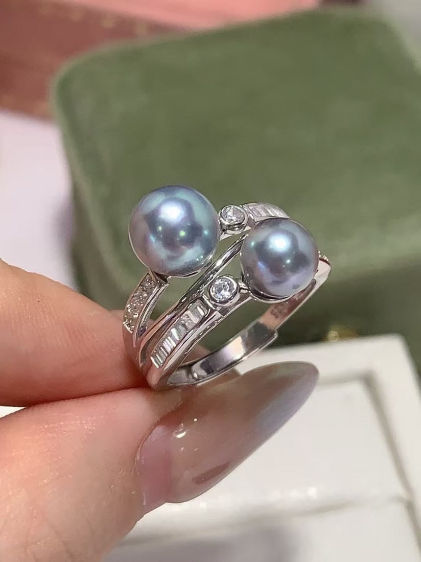 7-6mm Japanese Seawater Akoya Pearl with Crystal Ring: 7-6mm Japanese seawater Akoya Pearl with rhinestones ring, made of solid silver with a very strong electric blue luster, slightly flawed overall. Reserve: $200.00 Shipping:Domestic: Shipping rates