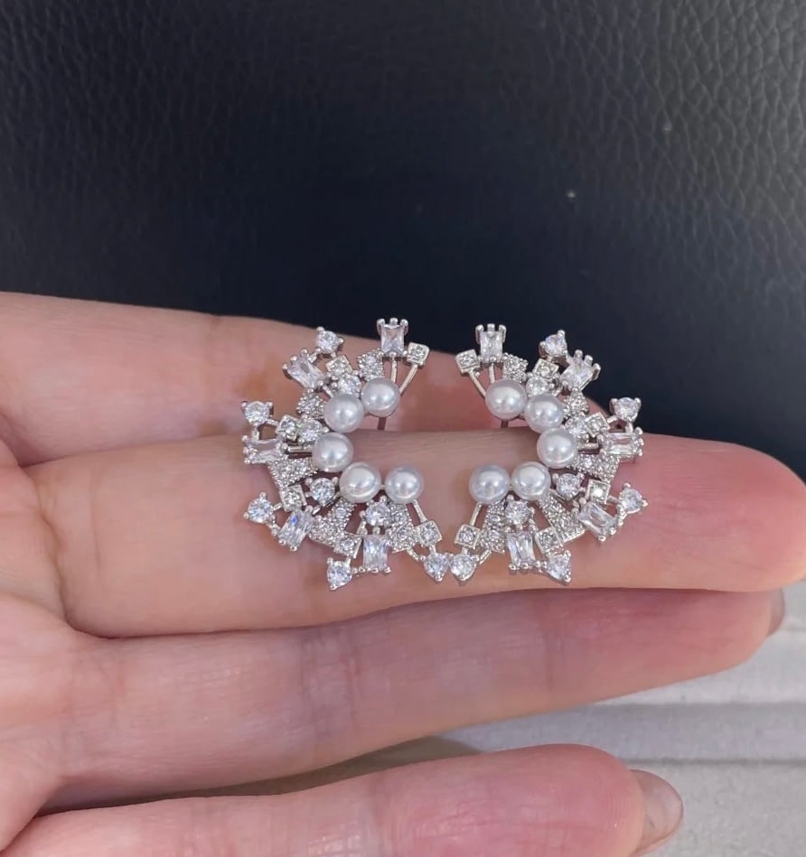 Pearl stud earrings with fireworks design: Pearl Stud Earrings with Firework Design Reserve: $100.00 Shipping: Domestic: Shipping rates are determined by destination International: Foreign shipping rates are determined by destination. Internat