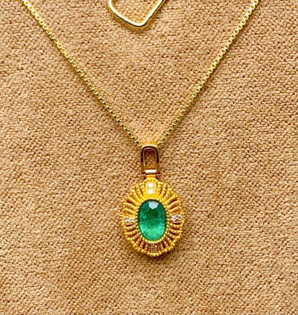 18k Gold with Diamond Encrusted Natural Emerald Pendant: 18k Gold Plated Diamond Set Natural Emerald Pendant (Chain Not Included), Total Weight: 0.95g Main Stone: Approximately 0.45ct Diamonds: 8 Reserve: $500.00 Shipping:Domestic: Shipping rates are