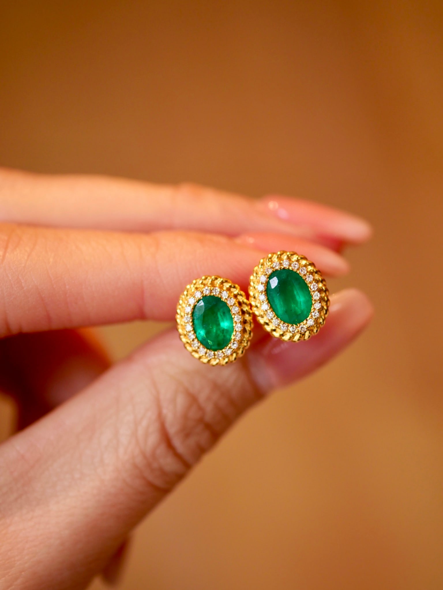 Pair of 18K Gold Emerald Details Diamond Stud Earrings: Pair of 18K gold emerald and diamond earrings, emerald 1.4ct, diamond 0.18ct Reserve: $1,200.00 Shipping:Domestic: Shipping rates are determined by destinationInternational: Foreign shipping rates