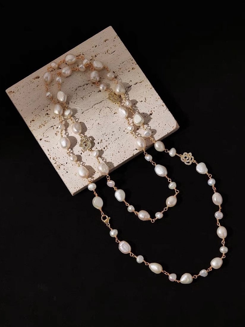 Pearl Necklace: Pearl sweater chain. Adorned with full-diamond camellia flowers, featuring two sizes of irregular pearls, hand-woven, 120 centimeters long Reserve: $150.00 Shipping: Domestic: Shipping rates are deter