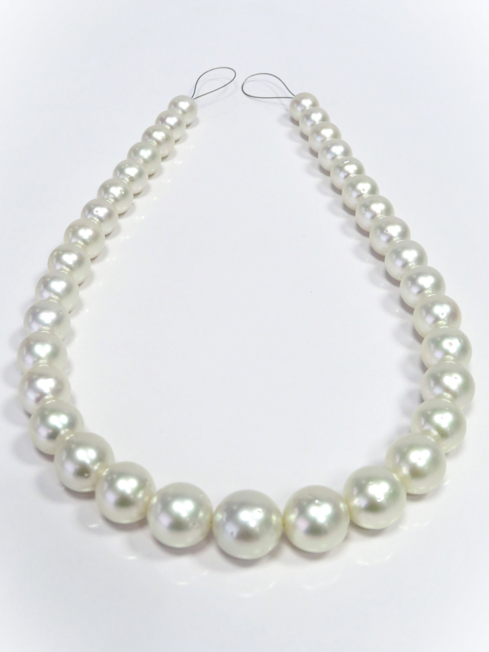 10-15mm Round White South Sea Pearl Necklace Strand: Title:10-15mm Round White South Sea Pearl Necklace Strand Description:A-AA Grade High luster, Round White, with minimal spots/blemishes, 35 pearl pieces, 18 inches long hand-knotted with 14k YG fish-h