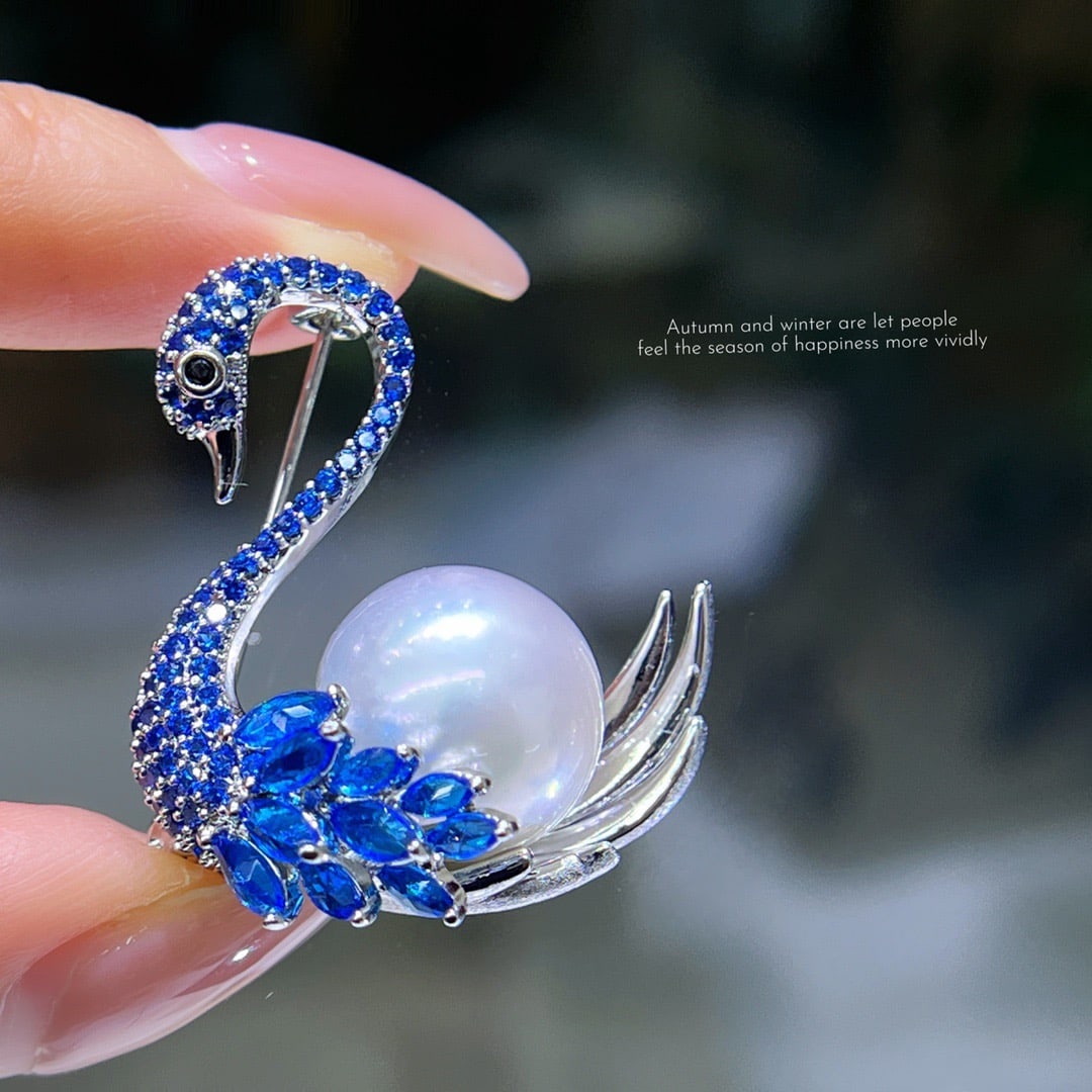 Swan Pearl Brooch: The blue gem on the swan's neck sparkles with brilliant radiance, the fine quality of the wings is comparable to the exquisite Australian white pearls. Reserve: $200.00 Shipping:Domestic: Shipping