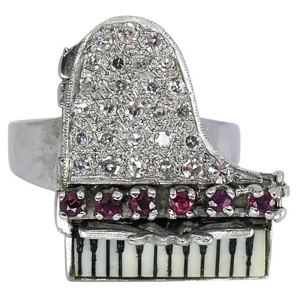Vintage 14k Gold Grand Piano Diamond Gemstone Ring: Title: Vintage 14k Gold Grand Piano Diamond Gemstone Ring Description: This vintage 14k gold ring showcases a creative grand piano design, highlighted by a pavé diamond lid and richly colored