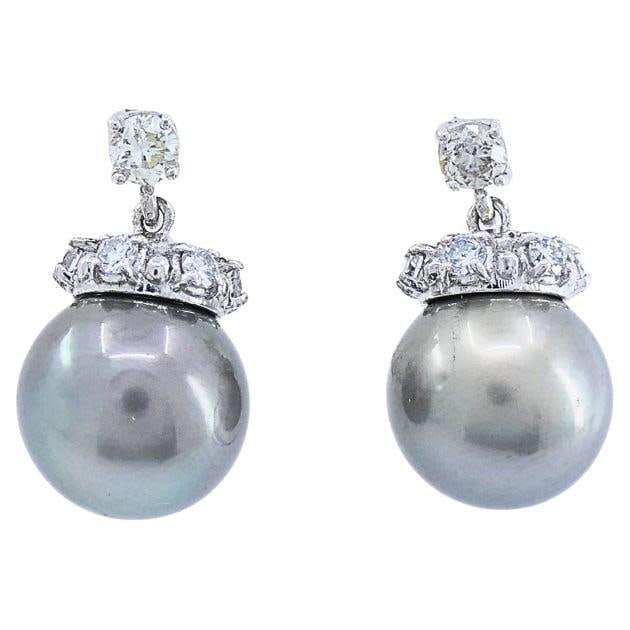 Tahitian Pearl Diamond 14k Gold Stud Earrings: Title: Tahitian Pearl Diamond 14k Gold Stud Earrings Description: MATERIALS: 14k Gold GEMSTONE: Pearl, Diamond WEIGHT: 7.7 Grams MEASUREMENT: Pearl Diameter - 7/16" HALLMARKS: 14K ITEM DETAILS: These