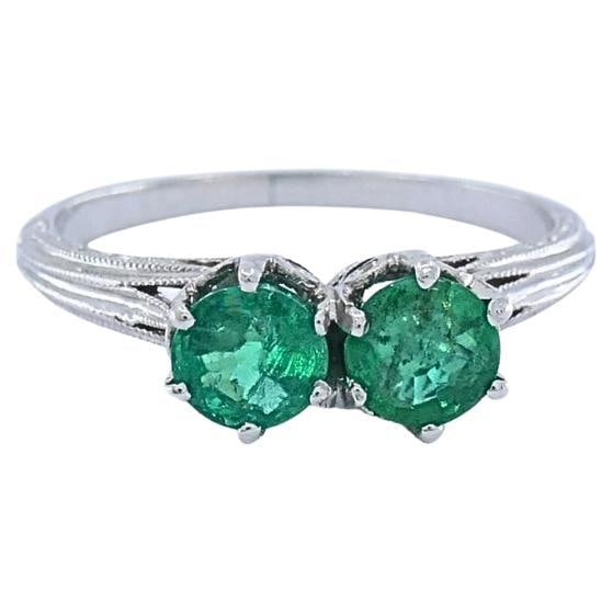 Vintage Platinum Toi et Moi Emerald Ring: Title: Vintage Platinum Toi et Moi Emerald Ring Description: This vintage platinum ring features two round green emeralds set side by side in classic prong baskets, creating a balanced two‑stone
