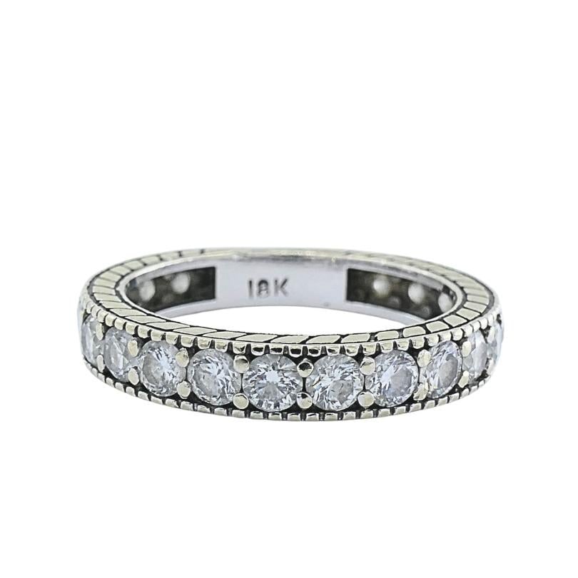 18k White Gold Diamond Eternity Band Ring: Title: 18k White Gold Diamond Eternity Band Ring Description: This 18k gold diamond eternity band ring features a continuous row of diamonds set around of the band. The top and bottom of the band disp
