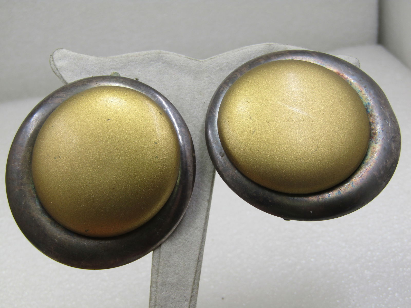 Vintage Kate Hines Brass Silver Tone 2" Earrings, Clip: Vintage Kate Hines Brass Silver Tone 2" Earrings, Clip. This have a large brass tone center piece that has a lower silver tone frame. There is movement with the brace that holds the clip. The clips ho