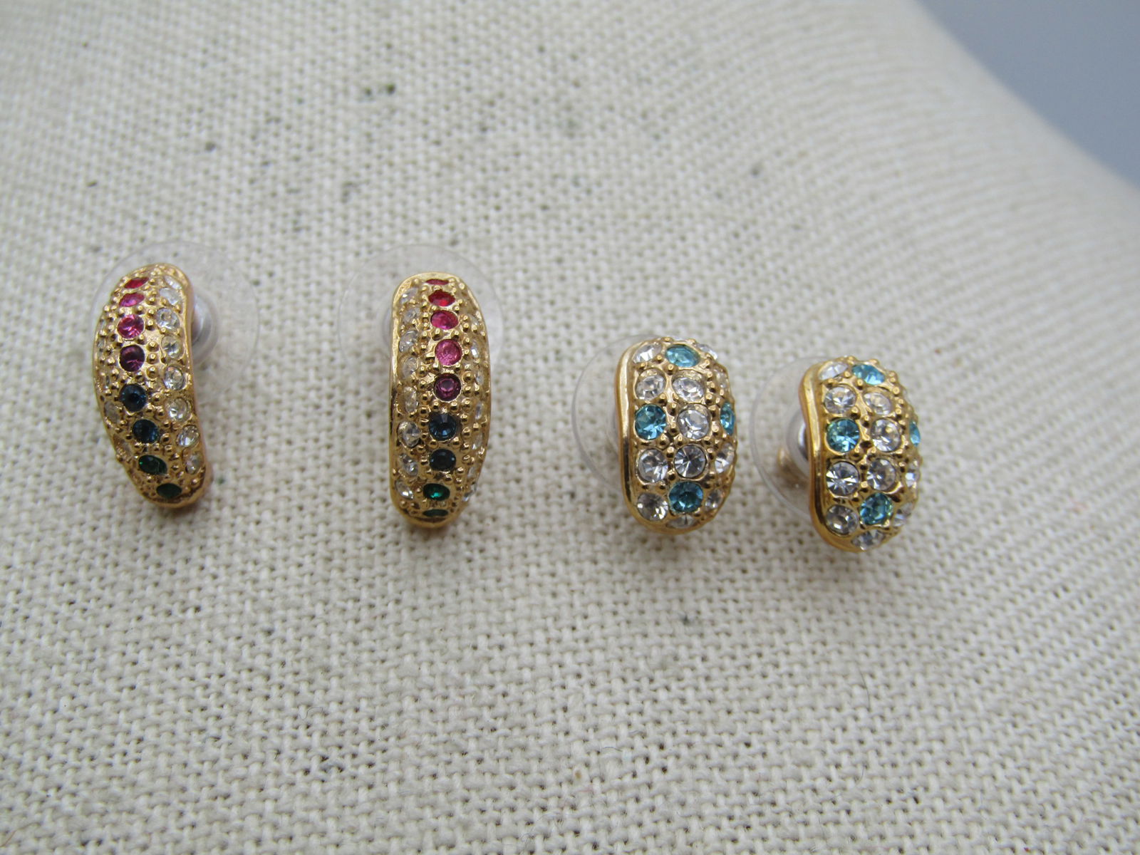 Two Pair of Rhinestone Half Hoop Earrings, Pierced, Signed Roman: Two Pair of Rhinestone Half Hoop Earrings, Pierced. One with clear rhinestonestones on the edges and pink, blue, green, purple down the center and the other with clear and aqua stones They are appx.