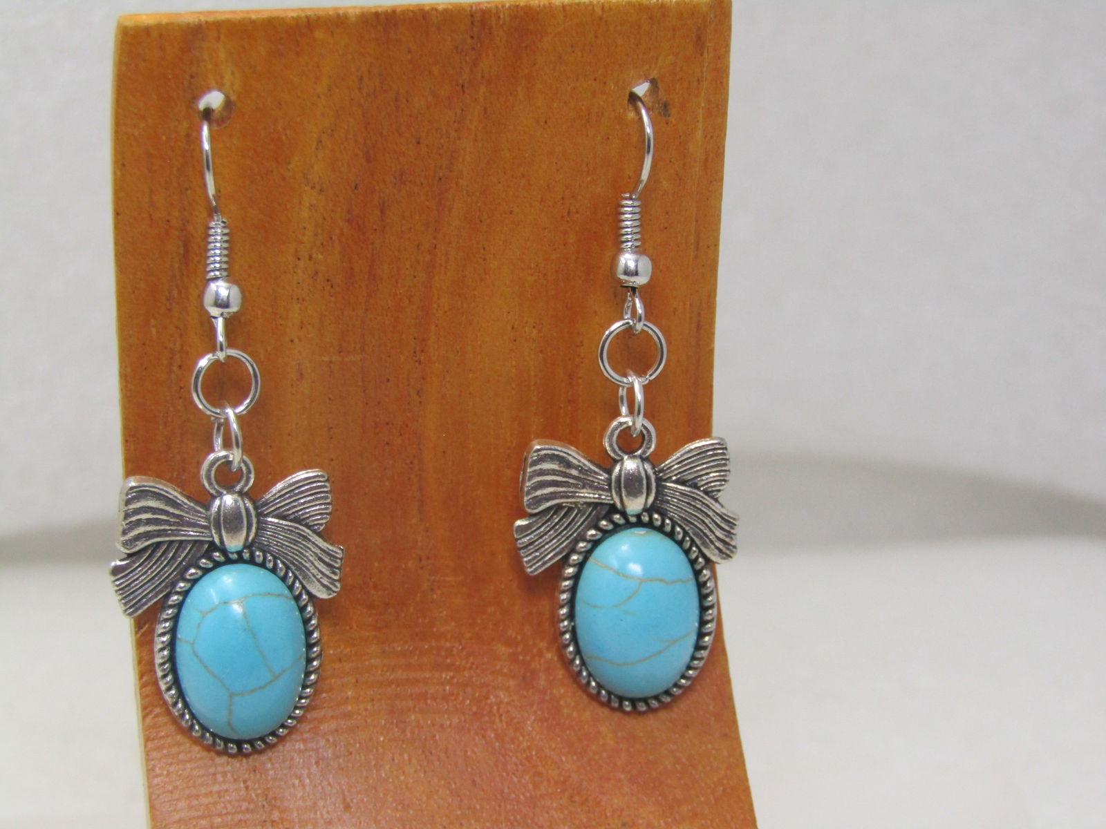 Faux Turquoise Bow Earrings, Pierced, 2": Faux Turquoise Bow Earrings, Pierced, 2". Southwestern vibe with a ridged bow set over the oval faux turquoise stone. Vintage new stock, 1980's-1990's. The drop itself is papx. 1" but measured from th
