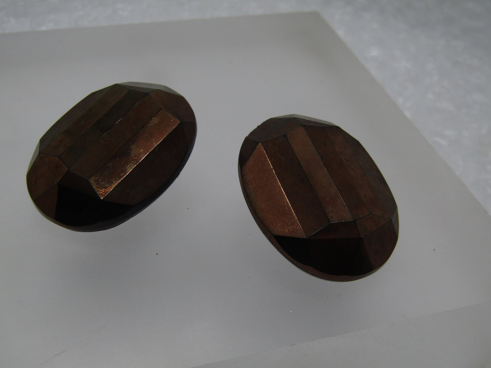 Vintage Metallic Copper Tone Faceted Earrings, Clip, Black Glass Base: Vintage Metallic Copper Tone Faceted Earrings, Clip, Black Glass Base. The earrings are faceted and a base of black glass with a metallic copper tone finish. They are appx. 1.25" long and 1" wide. Age