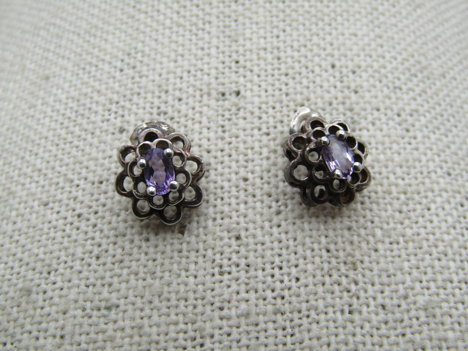 Vintage Sterling Amethyst Tiered Earrings, Pierced, 1980's-1990's.: Vintage Sterling Amethyst Tiered Earrings, Pierced, 1980's-1990's. Scalloped two tiers with open work and a center 4.5mm by 3mm oval amethyst set top center. The earrings are appx. 10mm across