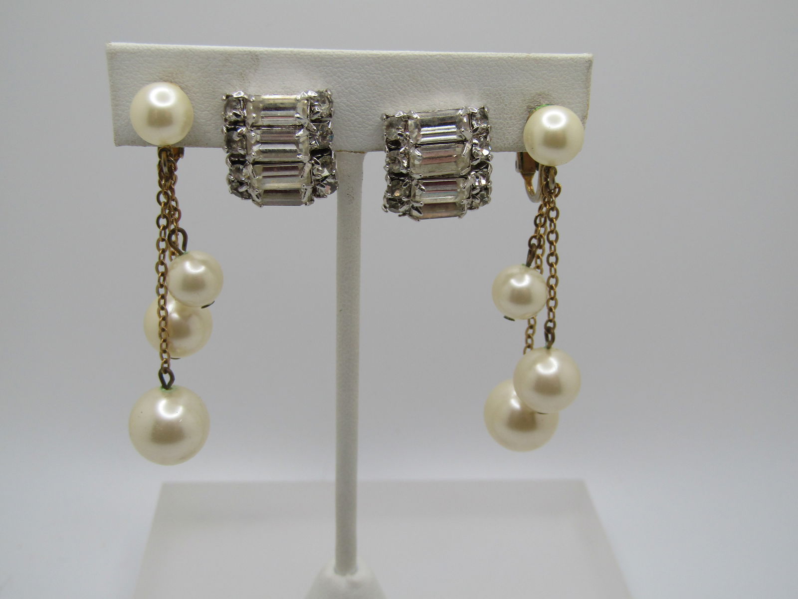 Vintage Pair of Rhinestone & Faux Pearl Earrings, 1950's: Vintage Pair of Rhinestone & Faux Pearl Earrings, 195. Thre are clear rhinestonie bridal style earrings that have a Patent 1967965 which was obtained by Ballou. These are silver tone clips with