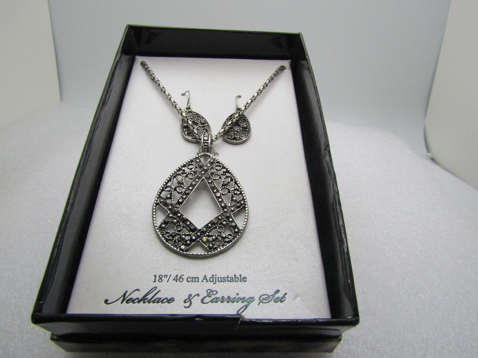 Faux Marcasite Teardrop Necklace/Earrings Set, 18", Boxed: Faux Marcasite Teardrop Necklace/Earrings Set, 18", Boxed. Pierced earings with openw ork and faux marcasites with a matching design on the pendant but larger and more open space. The pendant is