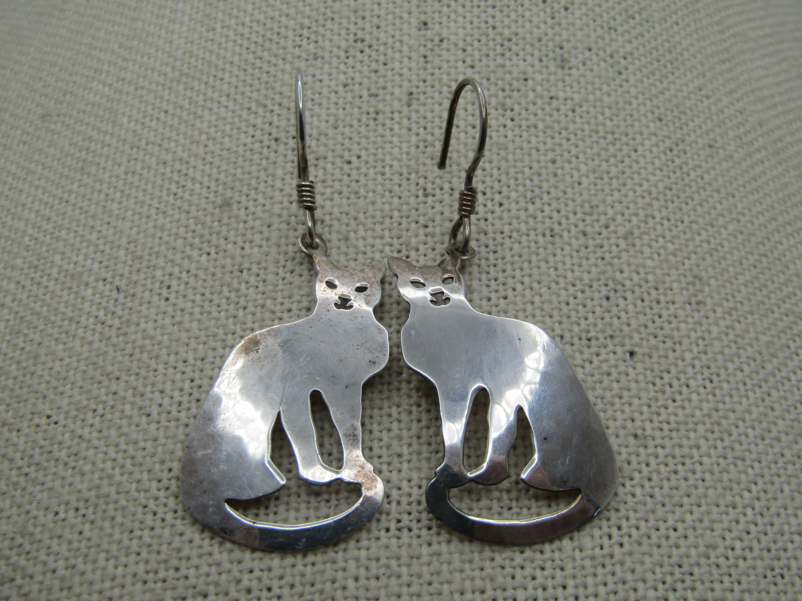 Vintage Sterling Hammered Cat Drop Earrings, Signed Wild Bryde, 1.75": Vintage Hammered Cat Drop Earrings, Signed Wild Bryde, 1.75" by 3/4" wide. Signed Sterling and Wild Bryde on the back. they have a smoother look, slightly domed on front and more hammered on the back.