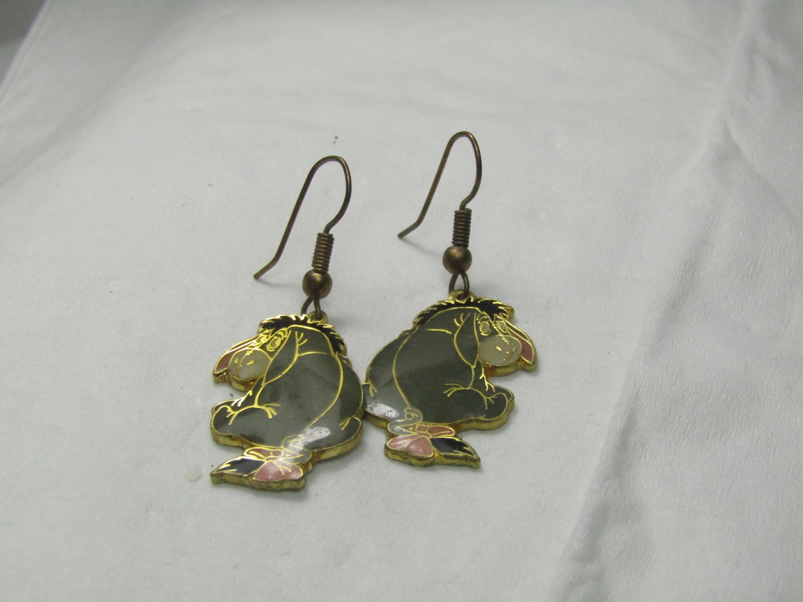 Vintage Disney Eeyore Pierced Earrings: Vintage Disney Eeyore Pierced Earrings, Dangle, Enameled in Gray with pink bow on tail, 1.5" Long and 3/4" wide. Gold Tone. Good condition, some wear. Great for the Winnie the Pooh and Eeyore collecto