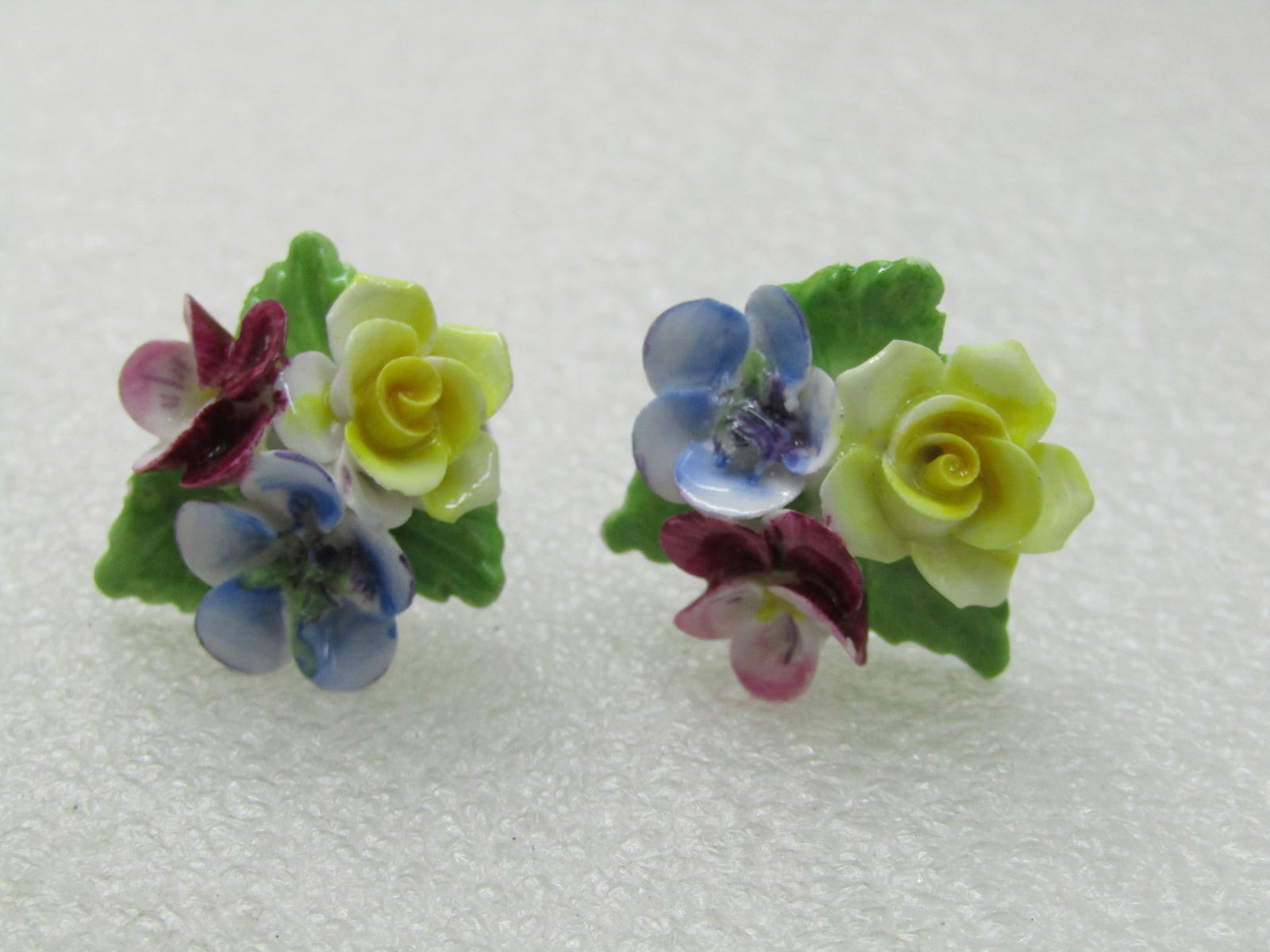 Vintage Porcelain Floral Earrings, Screw Back, 1970's: Vintage Porcelain Floral Earrings, Screw Back, 1970's, yellow roses, blue forget-me-not, and pink pansy with three green leaves, siler tone. Not signed by the maker. Very good condition. Do not see an