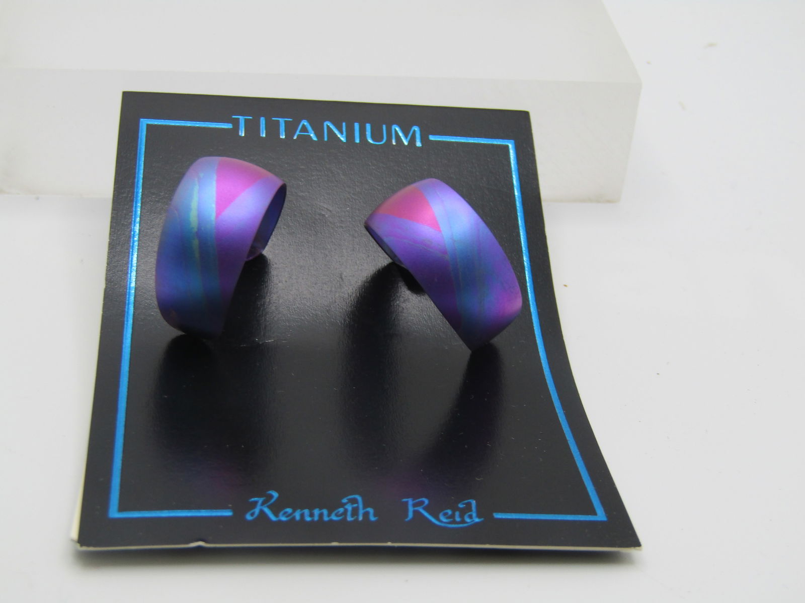 Kenneth Reid Titanium Pierced earrings, Magenta/Pink/Purple, New on Card: Kenneth Reid Titanium Pierced earrings, Magenta/Pink/Purple, New on Card. They are appx. 1" long and 1/2" wide. Age is estimated at 1900's. Very good condition - on original card. Clean. Kenneth Reid