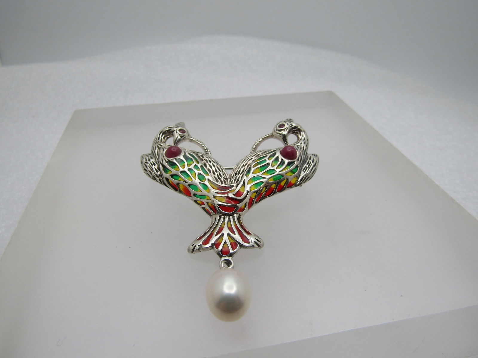 Vintage Sterling Enameled Stained Glass Bird Brooch, Double Bird, Drop Pearl: Vintage Sterling Enameled Stained Glass Bird Brooch, Double Bird, Drop Pearl. The brooch has green, red, yellow, enameling creating a stained glass look through the wings and tail. Two birds, touching