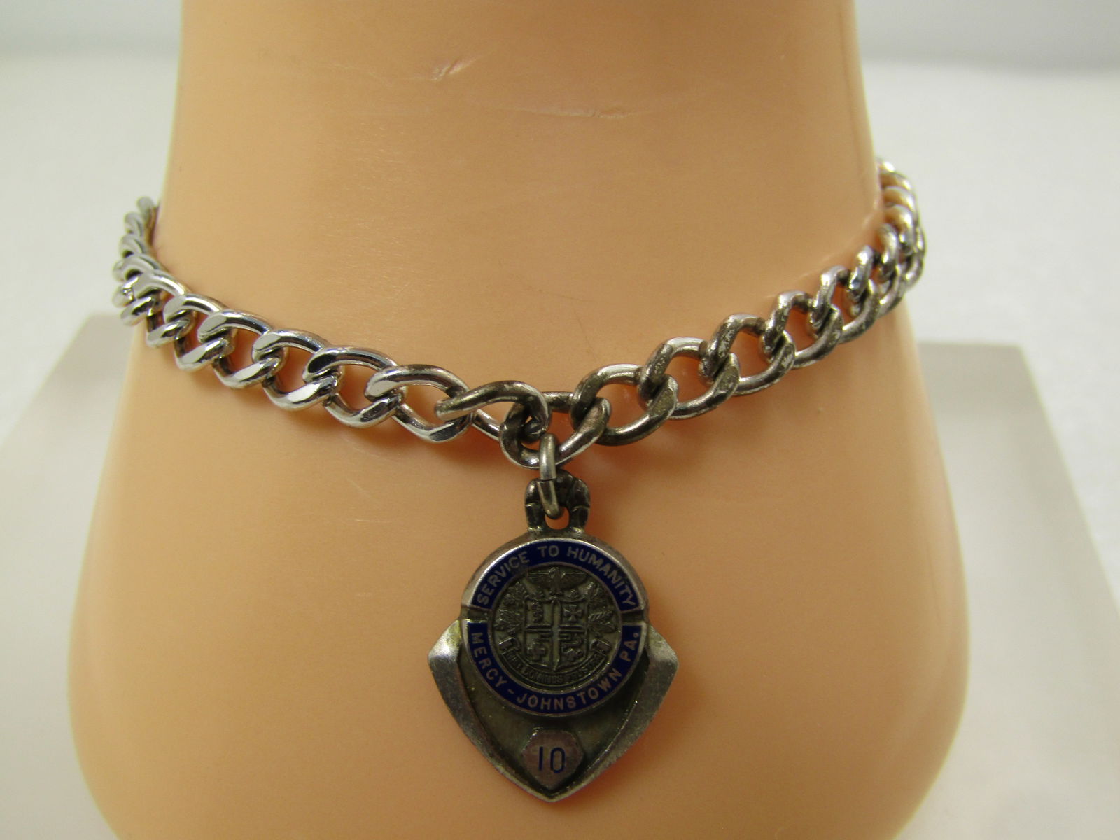 Vintage Sterling Charm Bracelet, Service to Humanity Service Charm, 7", 1960's-1970's: Vintage Sterling Charm Bracelet, Service to Humanity Service Charm, 7", 1960's-1970's. This is a 7" sterling bracelet that is appx. 5mm wide curb link with a single enameled banner Service to