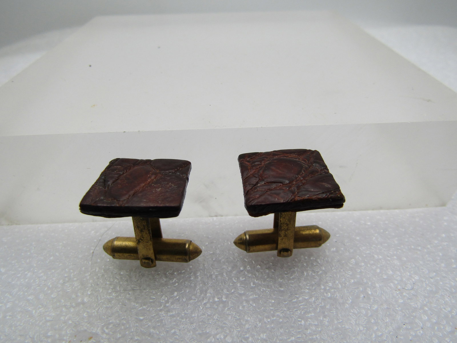 Vintage Leather Cufflinks Unisex, 1950's-1960's: Vintage Leather Cufflinks Unisex, 1950's-1960's. Brown leather that has been treated to remain stiff and is appx. 5/8" square with gold tone mechanism. Unisex. They arenot signed by themaker. 