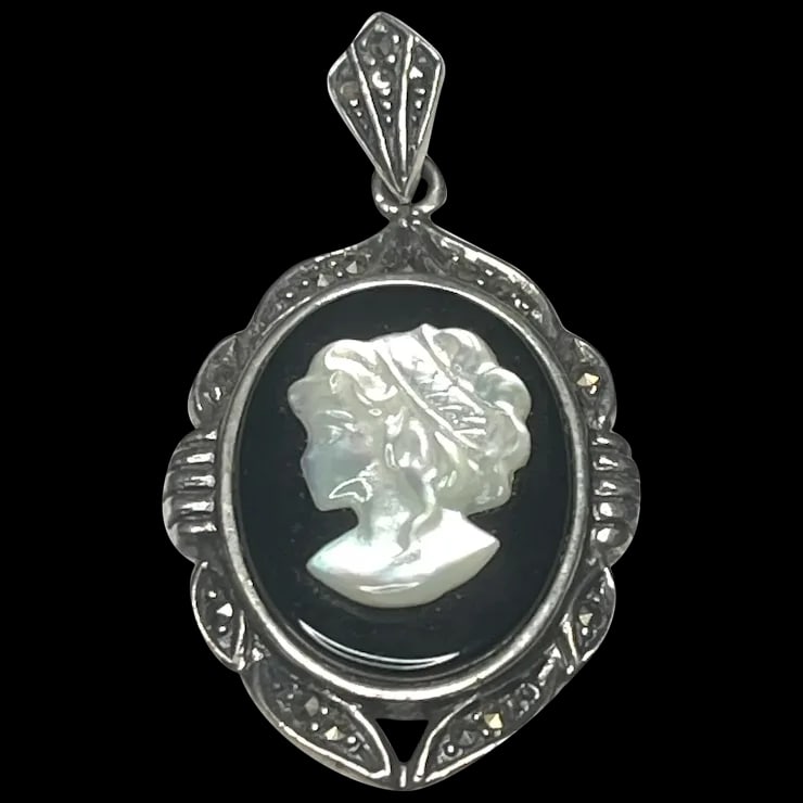 Vintage Sterling Silver and Marcasite Cameo Pendant: Title: Vintage Sterling Silver and Marcasite Cameo Pendant Description: Vintage Sterling Silver and Marcasite Cameo PendantHallmarked THAI, 925Weighs 6.4 gramsMeasures Approx. 1.50 x 1 inches 