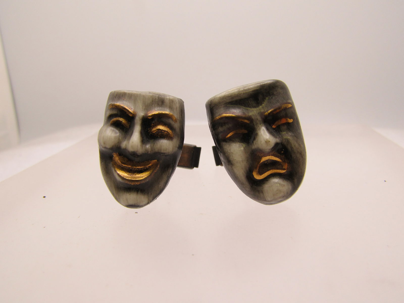 Vintage Comedy & Tragedy Cufflinks, 1940's-1950's, Copper: Vintage Comedy & Tragedy Cufflinks, 1940's-1950's, Copper mechanisms on back with a painted ceramic comedy and tragedy face with gold leaf mouth, eyebrows, eyelashes and a black/gray/white glaze. 