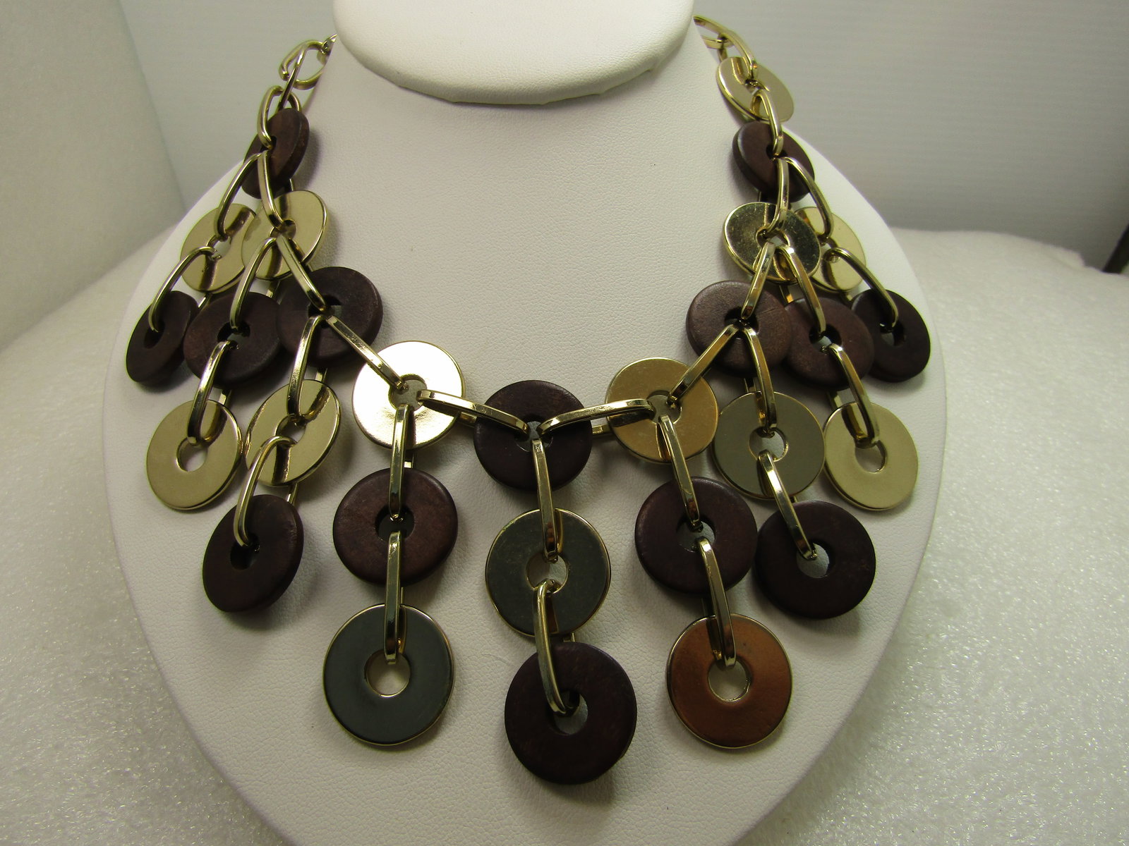 Gold Tone/Wood Disc Beaded Bib Necklace, 20"-23", 1980's-1990's: Gold Tone/Wood Disc Beaded Bib Necklace, 20"-23", 1980's-1990's. Large oval links make up the necklace around the neck and the drops of the bid which hold flat gold tone disc beads and slightly