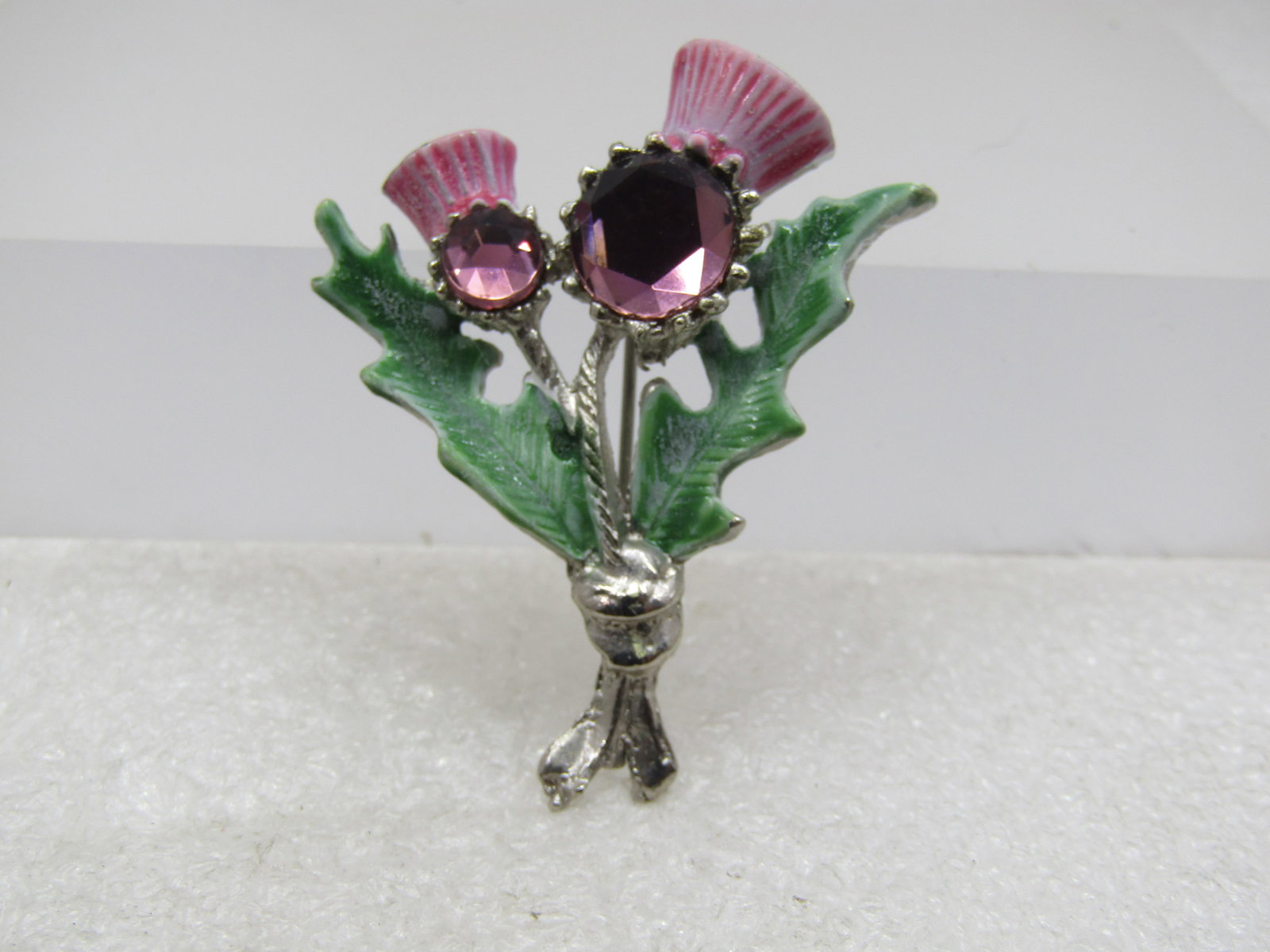 Vintage Purple Rhinestone Thistle Brooch, Signed Hollywood, 1950's-1960's: Vintage Purple Rhinestone Thistle Brooch, Signed Hollywood, 1950's-1960's. This has pink enameled tops tops with two purple thinestones, one larger than the other and green enameled leaves. The rhines