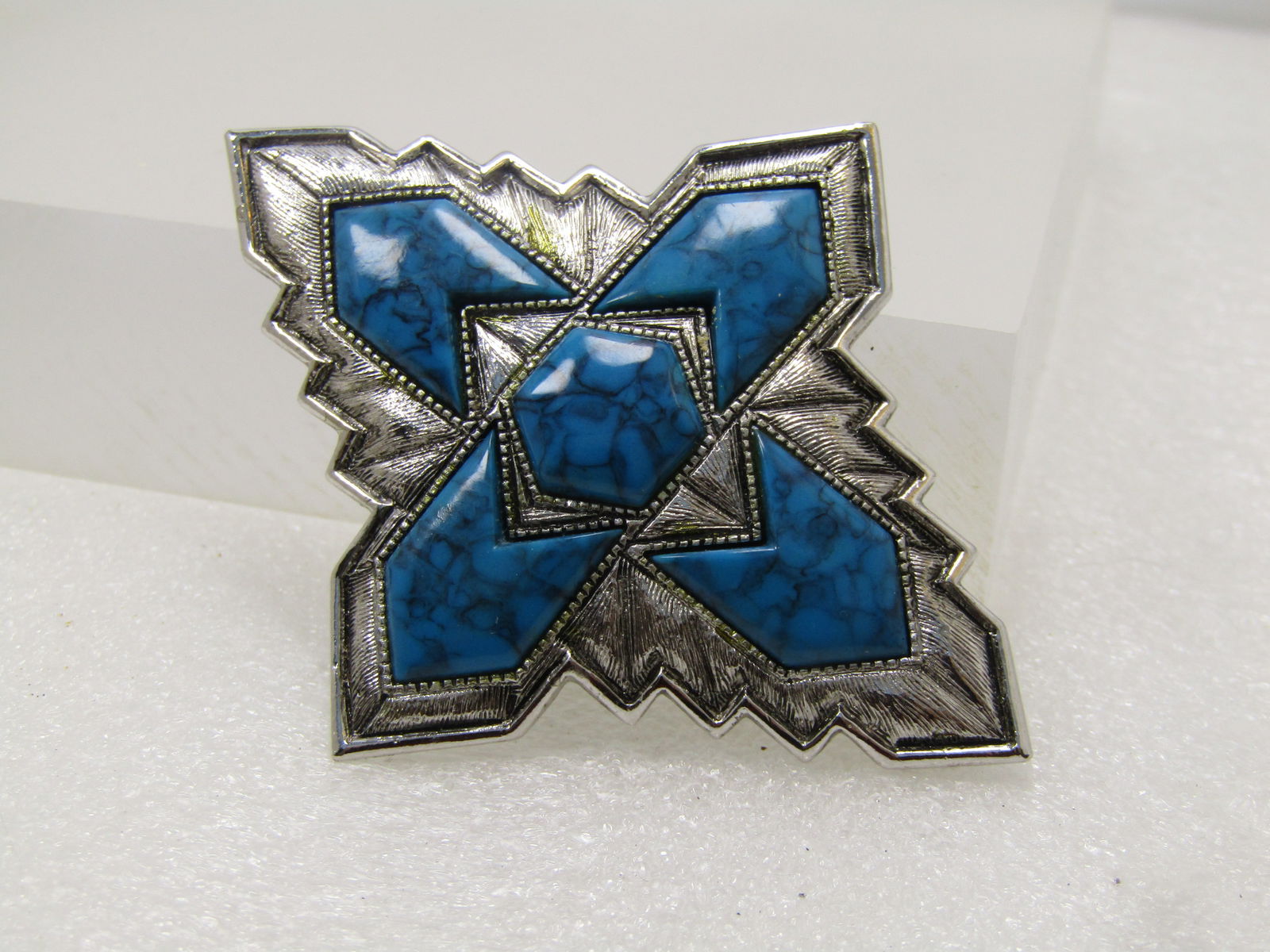 Vintage Southwestern Faux Turquoise Brooch, Sarah Coventry, 1960's-1970's: Vintage Southwestern Faux Turquoise Brooch, Sarah Coventry, 1960's-1970's. Silver tone with a crosslike design. It is appx. 2.75" by 2.25". Silver tone with a textured and smooth and shiny finish